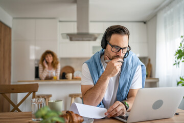 Wall Mural - One man caucasian male freelancer work from home on laptop computer