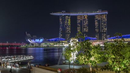 Wall Mural - The Merlion fountain spouts water in front of the Marina Bay Sands hotel in Singapore timelapse hyperlapse.