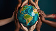 © MP Studio - Multiple hands of diverse skin tones coming together to carefully hold a globe, symbolizing unity, diversity, and global cooperation