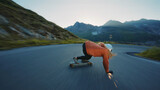 Fototapeta Nowy Jork - woman skateboarding and making tricks between the curves on a mountain pass.