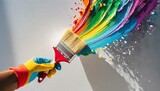 Fototapeta Sport - Hand with glove holding paint brush with rainbow color paint splash on white wall background