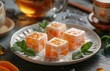 Artistic Tea and Citrus Dessert, Delicately crafted ice cream squares infused with citrus pieces, adorned with fresh mint, paired with aromatic tea for a refreshing dessert experience
