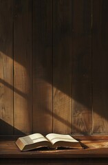 Wall Mural - Sunlight casts a golden hue on an open book lying on a wooden surface, inviting readers to a quiet literary retreat.