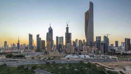 Wall Mural - Skyline with Skyscrapers day to night timelapse in Kuwait City downtown illuminated at dusk. Kuwait City, Middle East