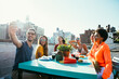 Group of friends apending time together on a rooftop in New york city, lifestyle concept with happy people