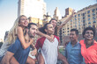 © oneinchpunch - Group of friends spending time together on a rooftop in New york city, lifestyle concept with happy people