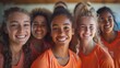 © Yulia - A group portrait of a diverse girls volleyball team, smiling confidently in their orange jerseys, embodying teamwork and camaraderie