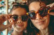 © Fotograf - A woman and a young girl wearing sunglasses. Suitable for summer fashion concept