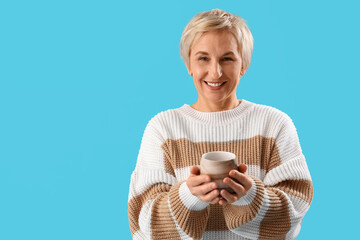 Sticker - Mature woman with cup of tea on blue background