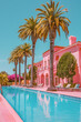 Pink house with palm trees and pool under azure sky