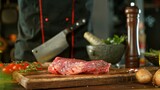 Fototapeta Lawenda - Raw Beef Steak Served on Wooden Cutting Board.