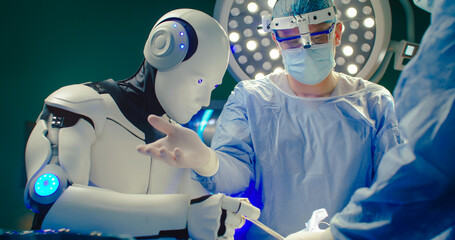 Medical artificial intelligence. Robotic surgery. Professional medical surgeon operates on patient in hospital with participation of robot. Innovative minimally invasive surgery with robotic system.