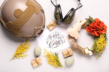 Sticker - Composition with greeting card, military equipment and beautiful Easter decor on light background