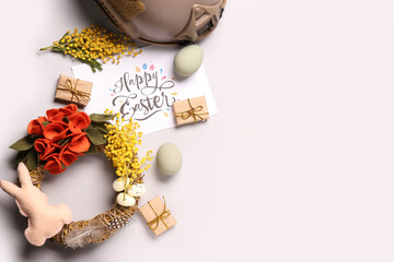 Poster - Composition with greeting card, beautiful Easter decor and military helmet on light background