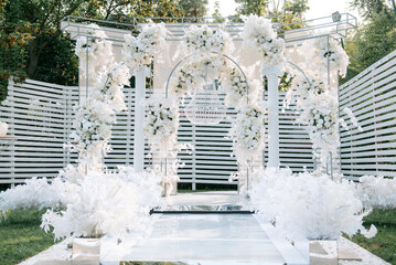 Wall Mural - Outdoor wedding photo zone decorated with flowers.