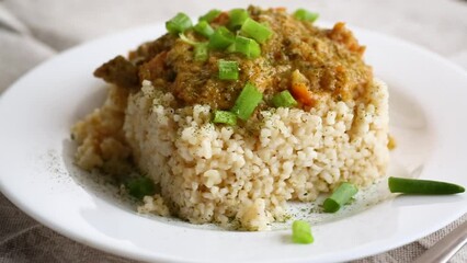 Wall Mural - cooked bulgur with meat sauce and vegetables in a plate