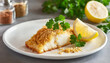 Baked cod fish with crispy coating with parsley and lemon.