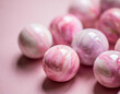 Elegant Pink Marbles Arranged Artistically on a Soft Pink Background