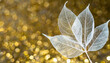 White transparent skeleton leaves with beautiful texture on a golden shiny abstract background blurred; wallpaper; lightness, weightless, pure concept