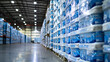 The image depicts a large stack of packaged bath tissue in a warehouse. Here are the details: The stack consists of neatly arranged packages of blue and white bath tissue