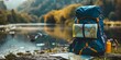 Backpack with map on the wild nature background. Hiking and camping equipment on the river in the forest, travel concept. Panoramic view with copy space.