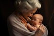 © Ari - Grandmother holds her newborn granddaughter in her arms and looks at her with a smile