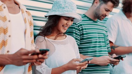 Canvas Print - Group, friends and texting with phone in city by garage for contact, blog or connection with diversity. Men, women or gen z people on smartphone, typing or reading for chat, streaming or social media