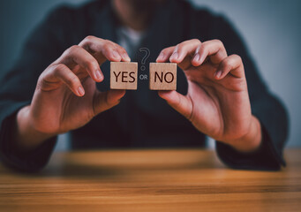 Wall Mural - Think With Yes Or No Choice, Business Choices For Difficult Situations, Yes or no and question mark, man holding two wooden with yes or no word on it, making decision.
