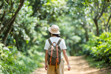 Canvas Print - Young woman walk on the trail in forest