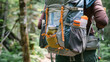A closeup of a hikers backpack filled with supplies for a daylong adventure picnic such as a map first aid kit and energy bars.