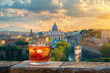 A classic Negroni cocktail with the city of Rome in the background