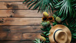 Vacation summer holiday travel tropical ocean sea banner panorama greeting card - Close up of straw hat, sunglasses pineapple and palm tree leaves, on wooden table, wood texture background.