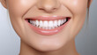 © mariiaplo - A close-up of a beaming smile showcasing pearly white teeth and healthy gums, set against a dark backdrop for contrast.