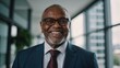 © VistaVisions - Portrait of successful black african american senior businessman headshot of executive consultant looking at camera smiling inside modern office building