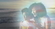 Image of happy african american mother and son at beach on sunny day smiling over sea