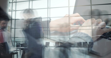 Poster - Image of hands using laptop over sped up commuters walking in modern building