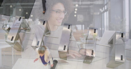 Poster - Image of smiling woman using laptop in cafe over businesswomen passing through station turnstile