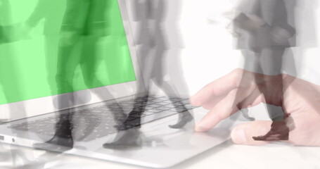 Poster - Image of hands using laptop with green screen over sped up commuters walking in modern building