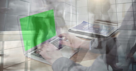 Poster - Image of hands using laptop with green screen over sped up commuters walking in modern building