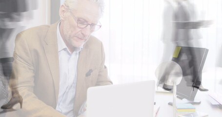 Poster - Image of businessman using laptop over sped up commuters walking in building