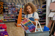 © Nomad_Soul - Happy girl child carrying shopping basket choosing studying supplies