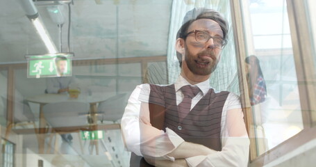 Poster - Image of businessman looking out of window over man and woman sitting in white room