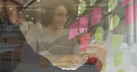 Poster - Image of smiling woman using laptop in cafe, over brainstorming businessman writing notes