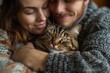 Affectionate couple embracing their beloved tabby cat, capturing a moment of love, warmth, and family bonding, evoking emotions of comfort, domestic life, and pet care concepts