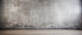 Fototapeta  - An empty room featuring a grey concrete wall and wooden flooring in shades of brown. The rectangular space resembles a monochrome landscape