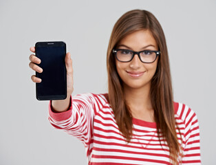 Poster - Portrait, woman and showing phone screen in studio isolated on a white background. Face, smartphone and happy person with display for advertising, marketing and mockup space on app for social media