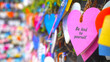 Colorful hearts on the street hanging on wall with text message - Be kind to yourself. Self love and care concept. Inspirational and self motivational quotes.