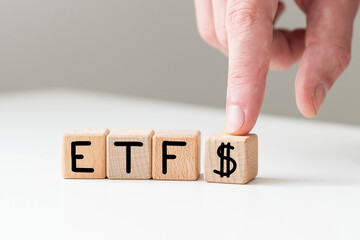 Exchange Traded Fund (ETF) and bitcoin cryptocurrency concept. Entering the digital money fund concept. Investor holds the wooden cube with bitcoin icon standing with ETF text. White background. 