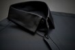 Zoomed-in view of an unbuttoned collar on a stylish dark shirt.