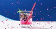 Image of confetti falling and cocktail on blue background